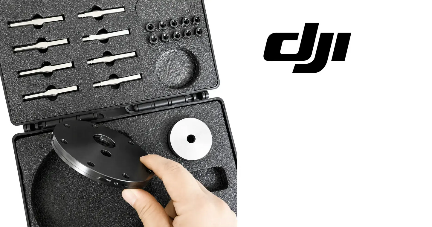 DJI bearing disassembly tool kit hand holding circular metal plate from foam case