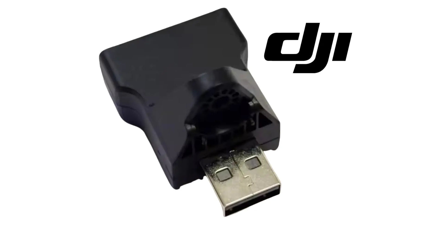 Black DJI Agras RTK adapter module with USB-A plug and port opening.