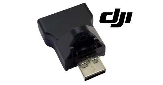 Black DJI Agras RTK adapter module with USB-A plug and port opening.