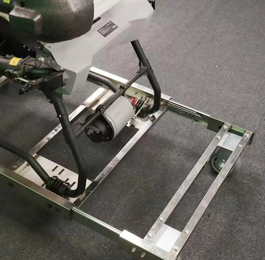 Metal drone transfer cart with mounting frame and actuator arm, green accents.