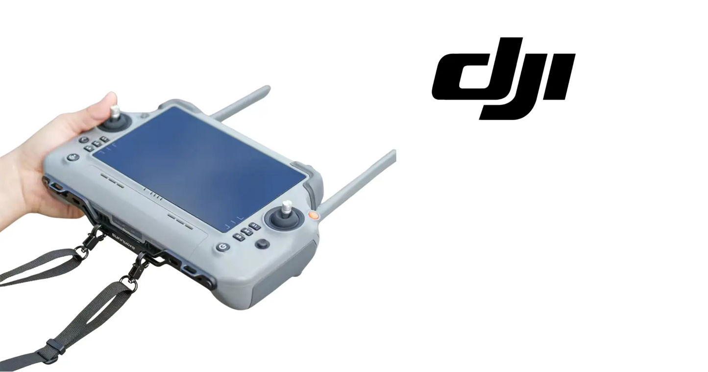 Gray DJI remote controller with neck strap attached, held in hand from the side
