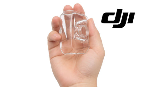 Hand holding clear square FPV camera lens protective cover with round opening