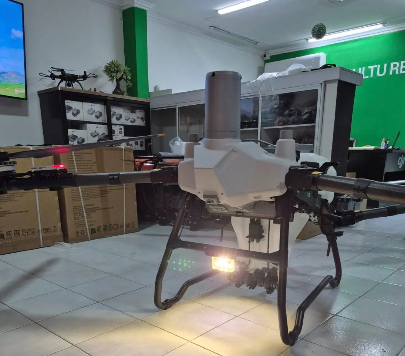 White agricultural sprayer drone with vertical tank and spray boom, 3/4 view
