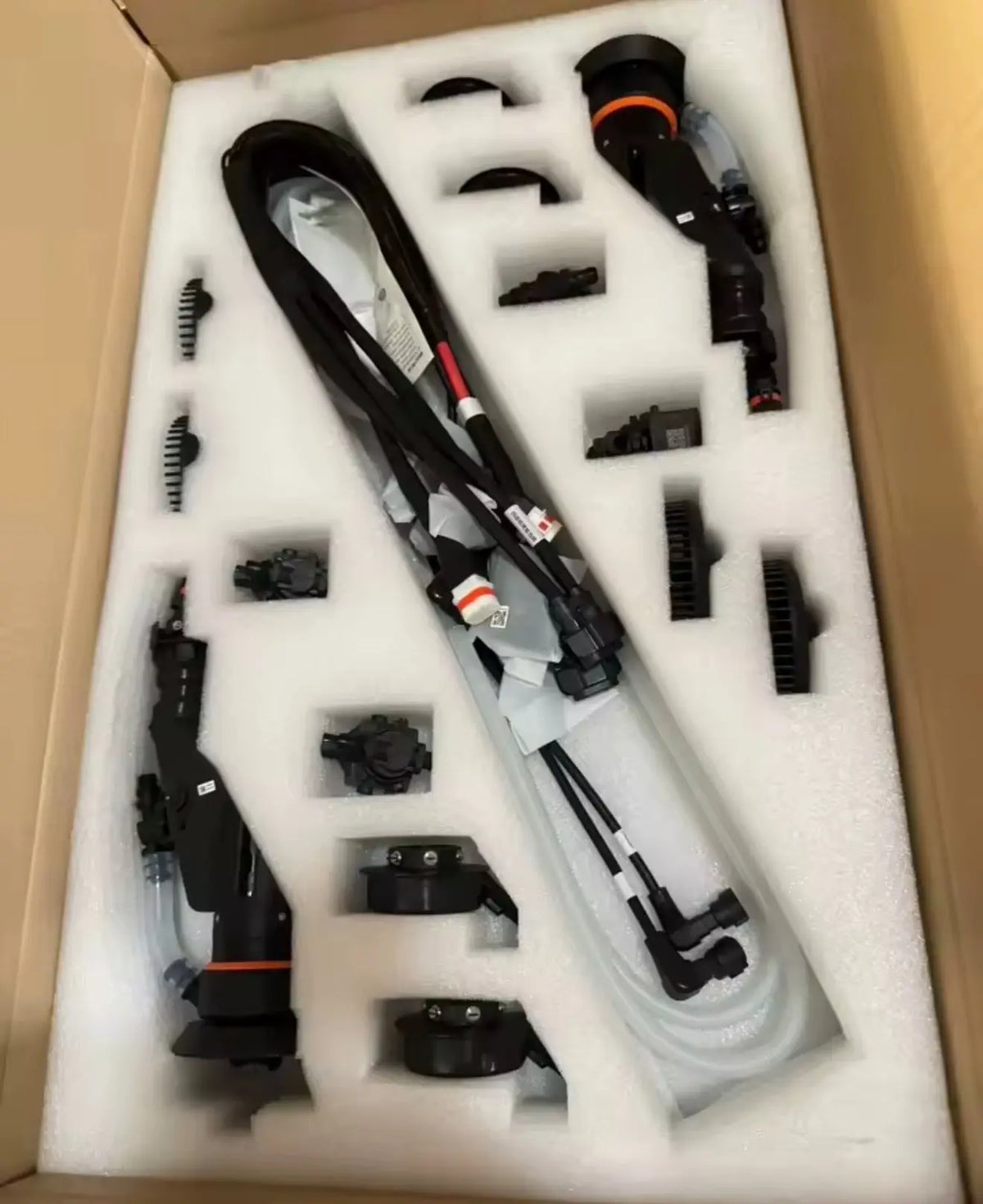Drone accessory kit in foam tray with cables, motors, and mounting hardware