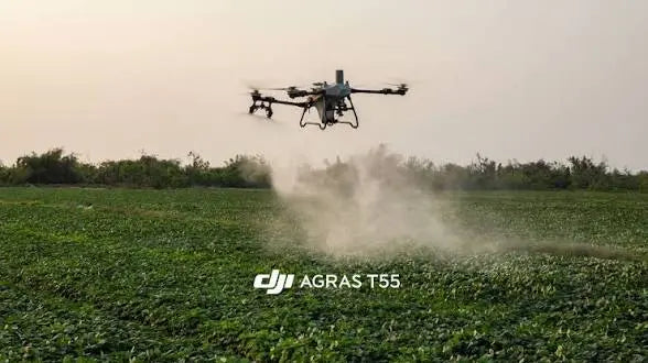 DJI Agras T55 agricultural sprayer drone releasing mist above a field