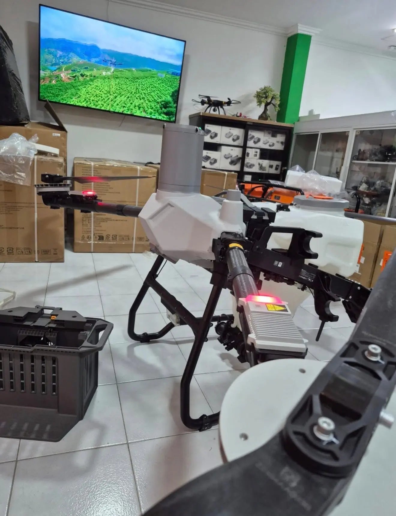 White agricultural sprayer drone with side spray boom, angled view