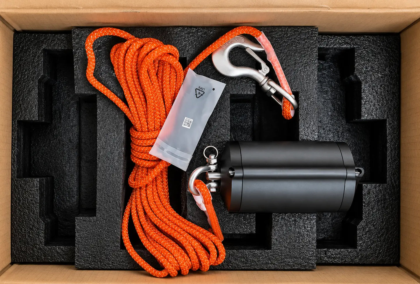 OEM lifting system in open box: black actuator, orange braided cable, foam insert
