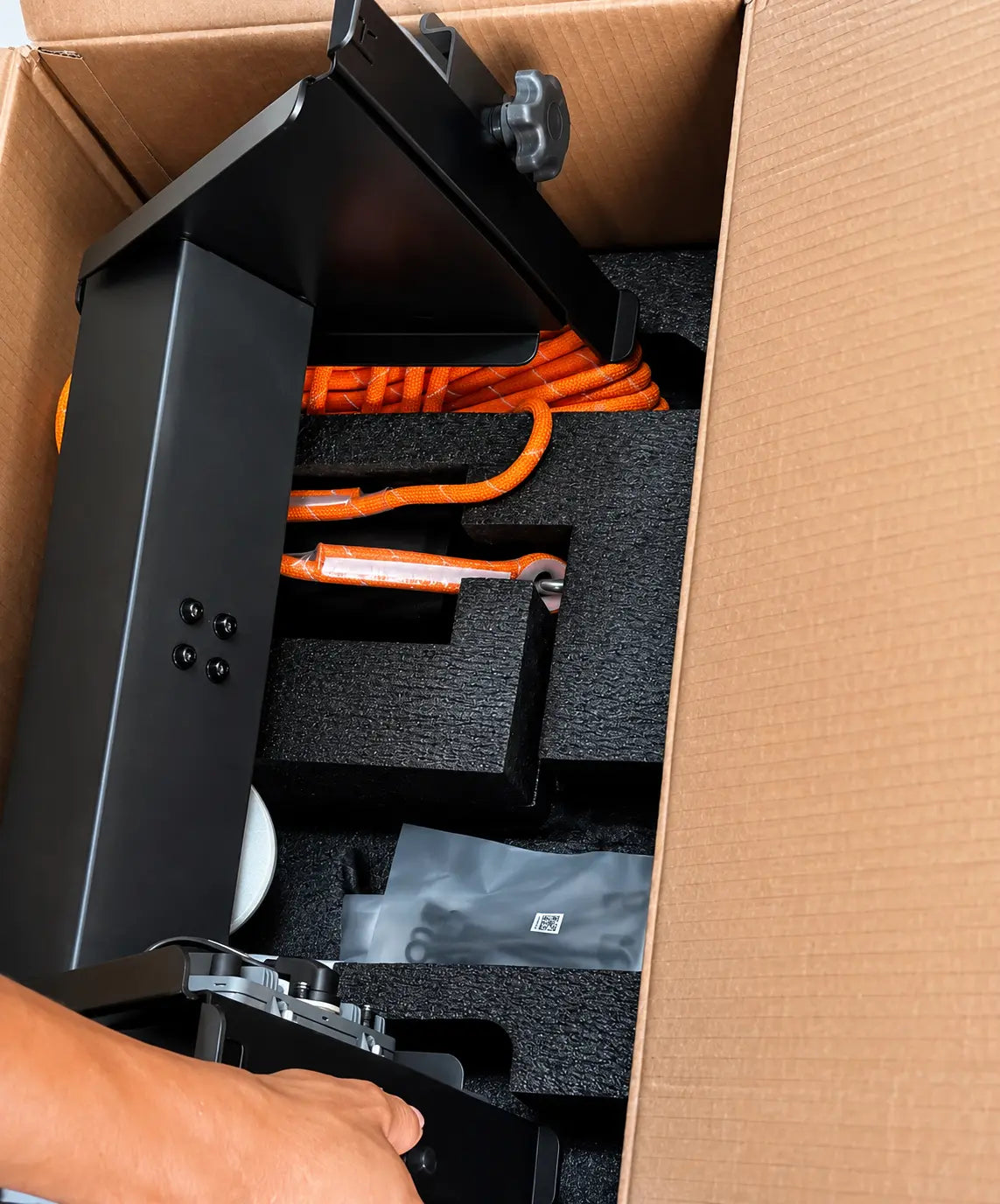 OEM lifting system components in cardboard box with orange braided cable and foam supports