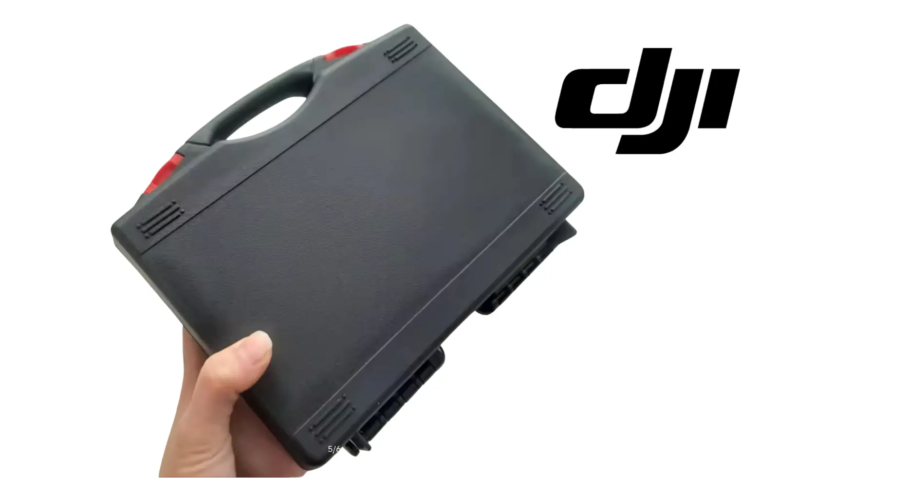 DJI Agras maintenance case held in hand, dark gray with handle