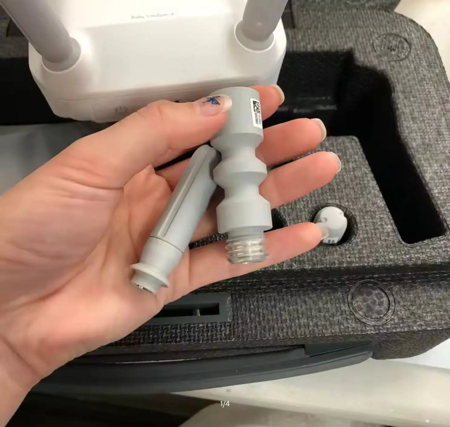 DJI signal repeater antenna module held in hand with two side arms