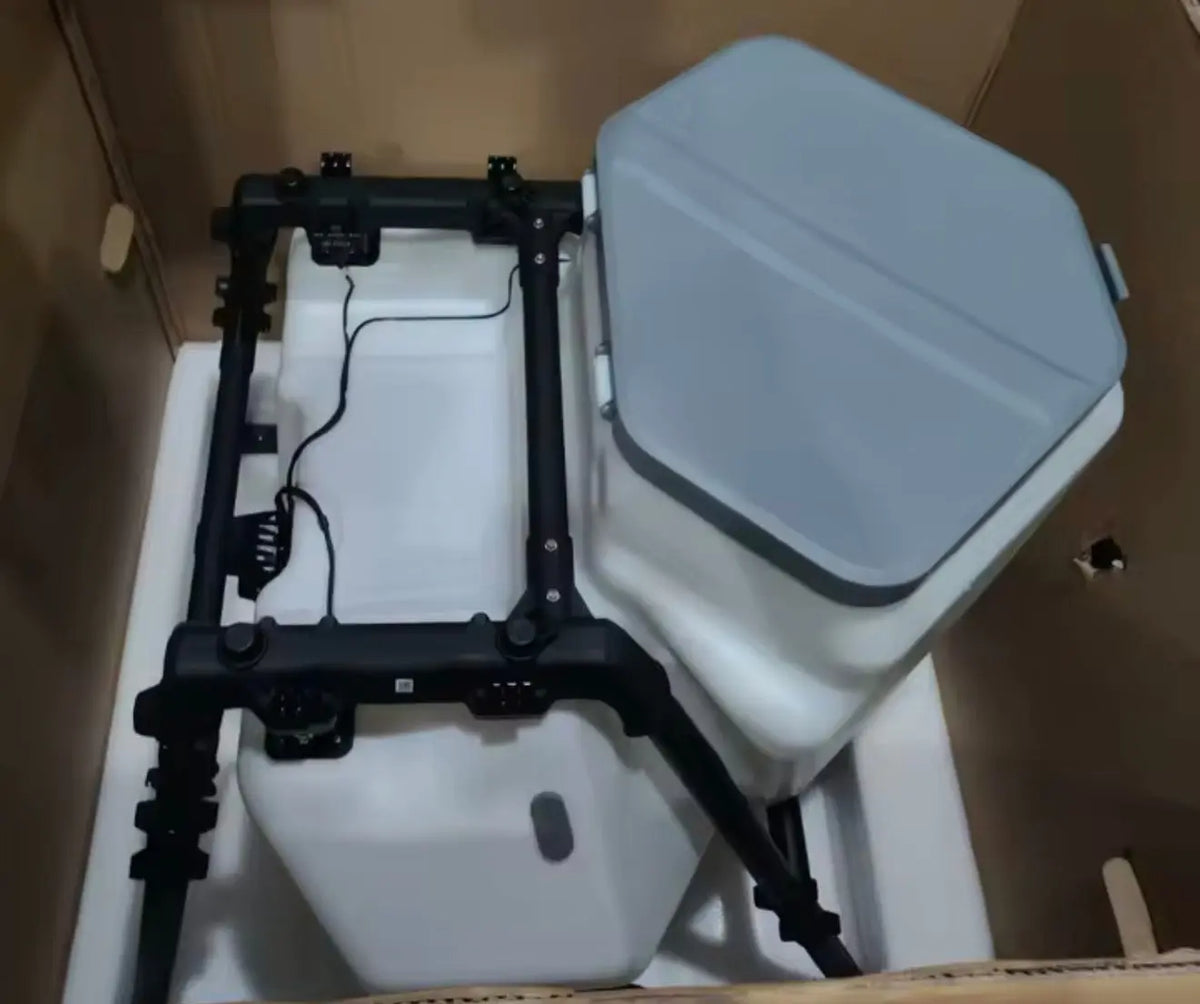 DJI Agras granular tank and spreader assembly with open frame and gray lid