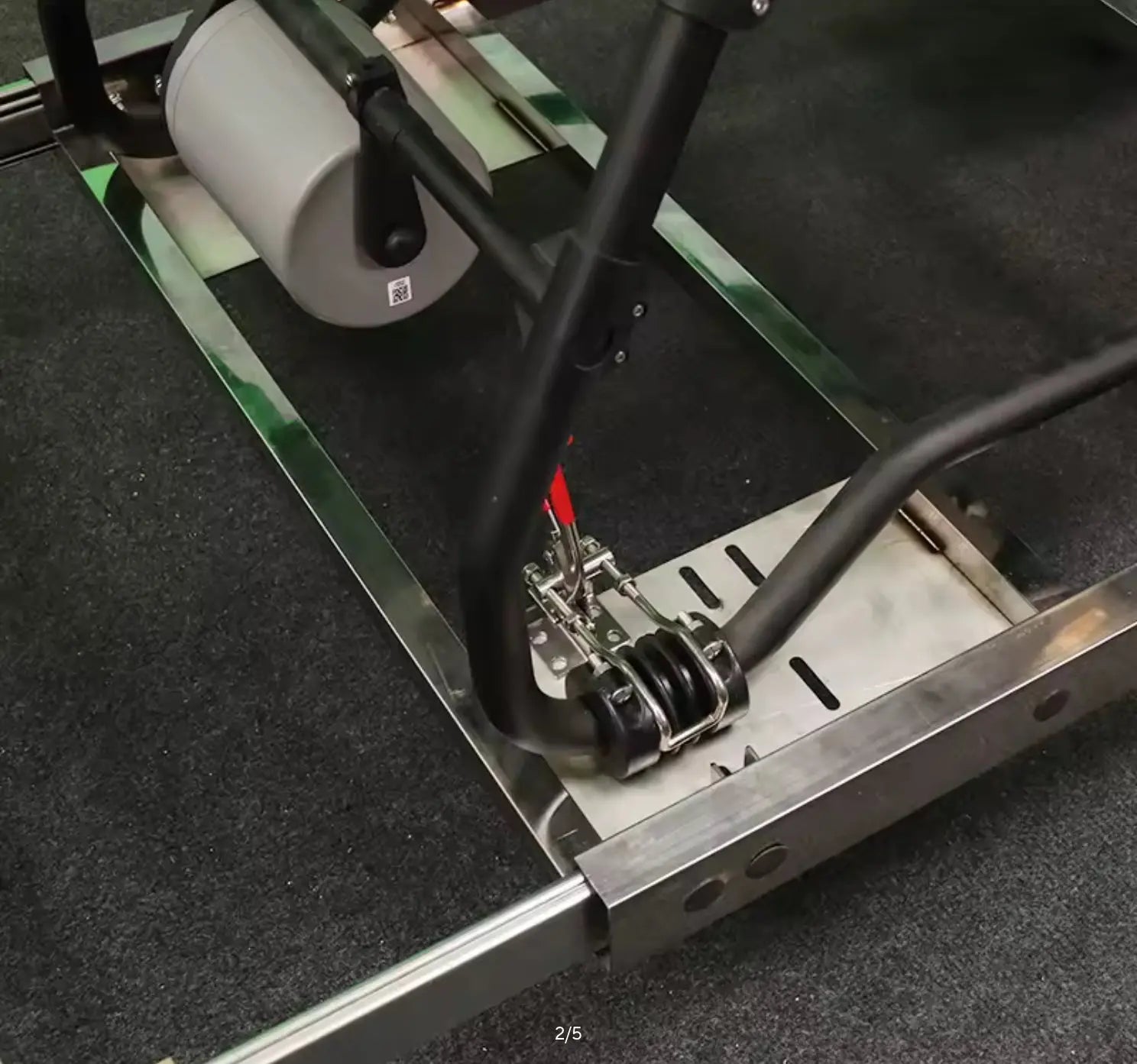 Drone transfer cart with side rails, mounting cradle, and caster wheels, silver and green.