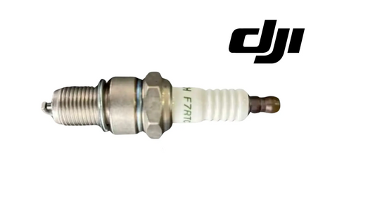Spark plug with hex metal body, ribbed threads, and brown electrode
