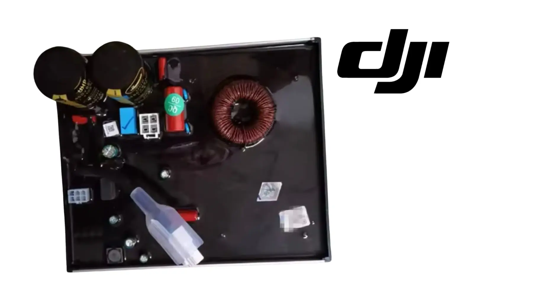 DJI inverter power module open with copper coil, parts, and wiring components