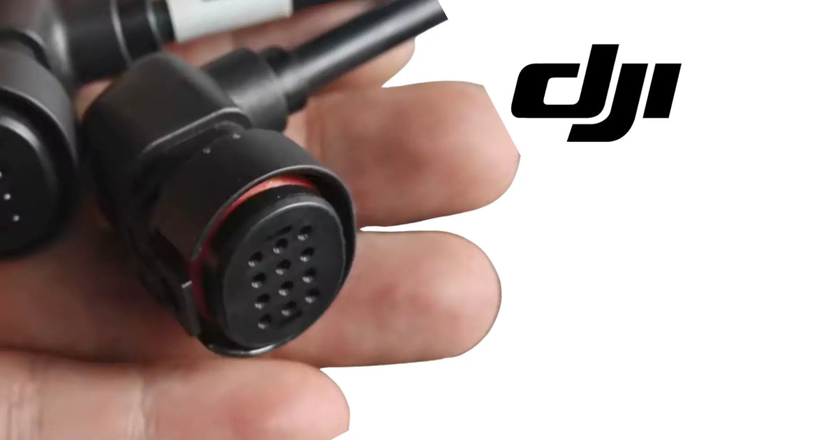 DJI Agras circular connector held in hand, showing red-ring multi-pin face