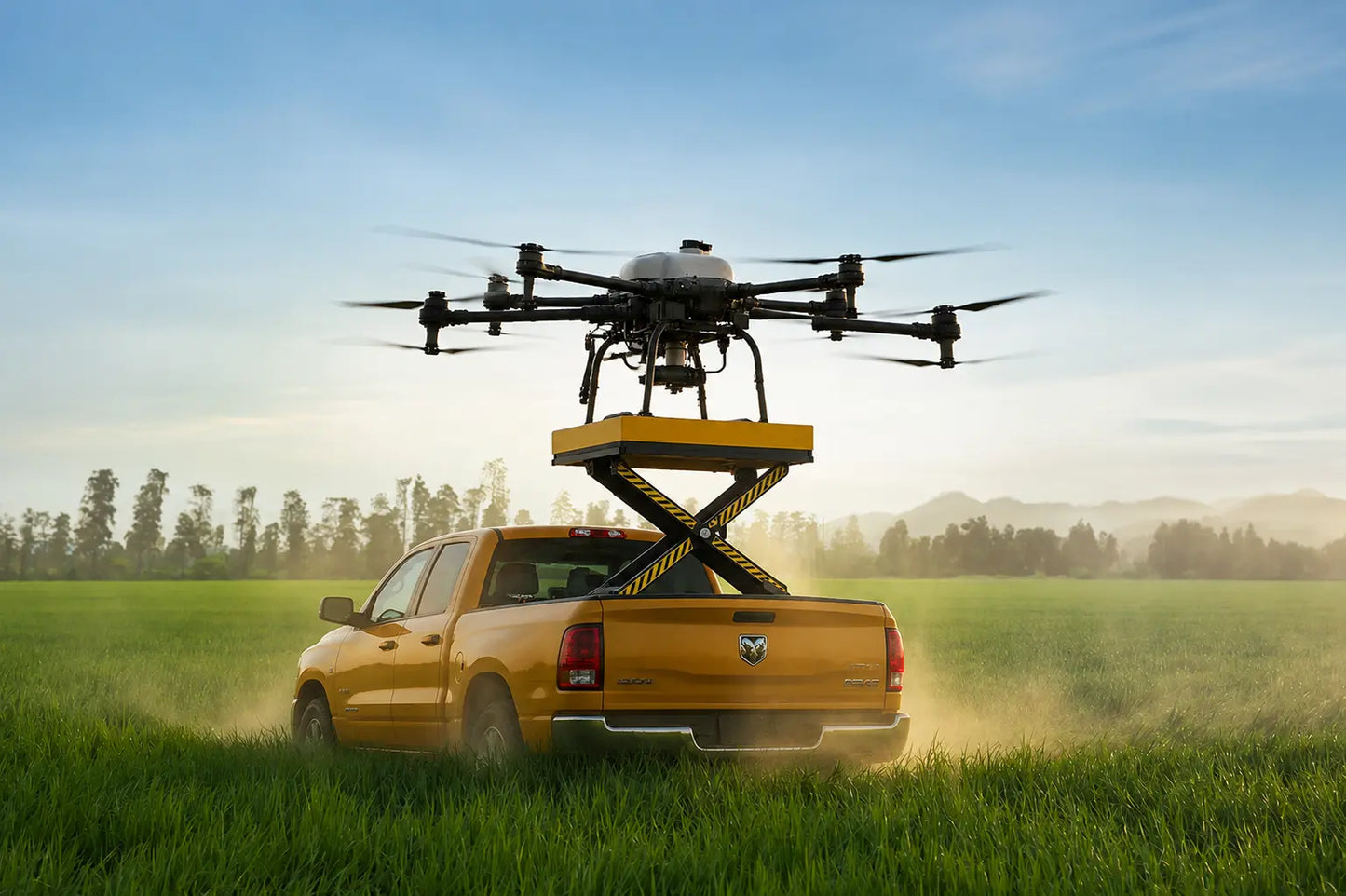 Agricultural drone lift platform with yellow scissor lift above pickup truck