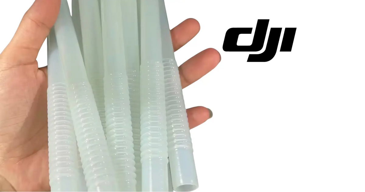 Hand holding translucent blue ribbed hoses with threaded ends for DJI T70
