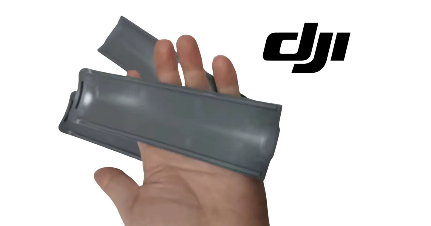 Dark gray vision cable cover plate, hand holding protective housing.