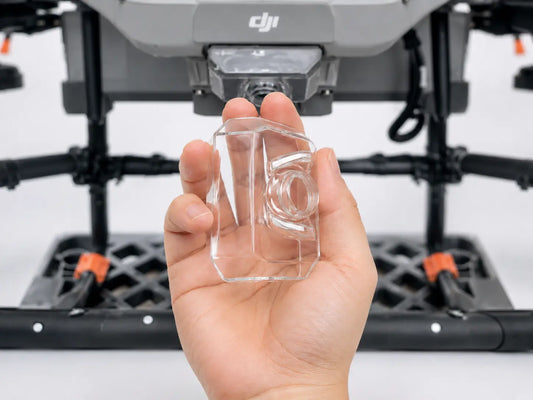 Clear FPV camera lens protective cover held in front of drone camera housing