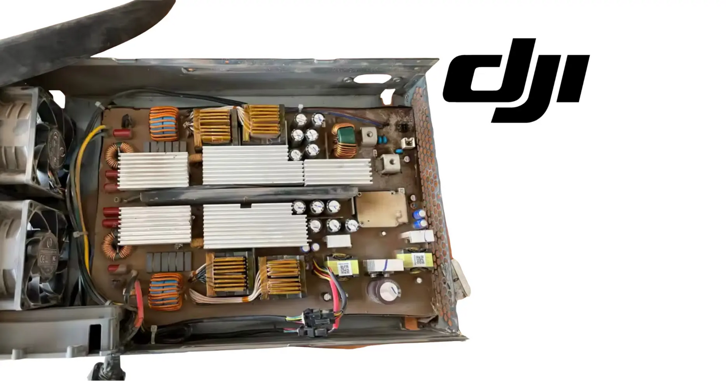DJI Agras AC-DC power module with exposed circuit boards and capacitors